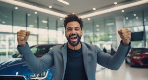 Happy young african american man standing in car showroom and raising hands up